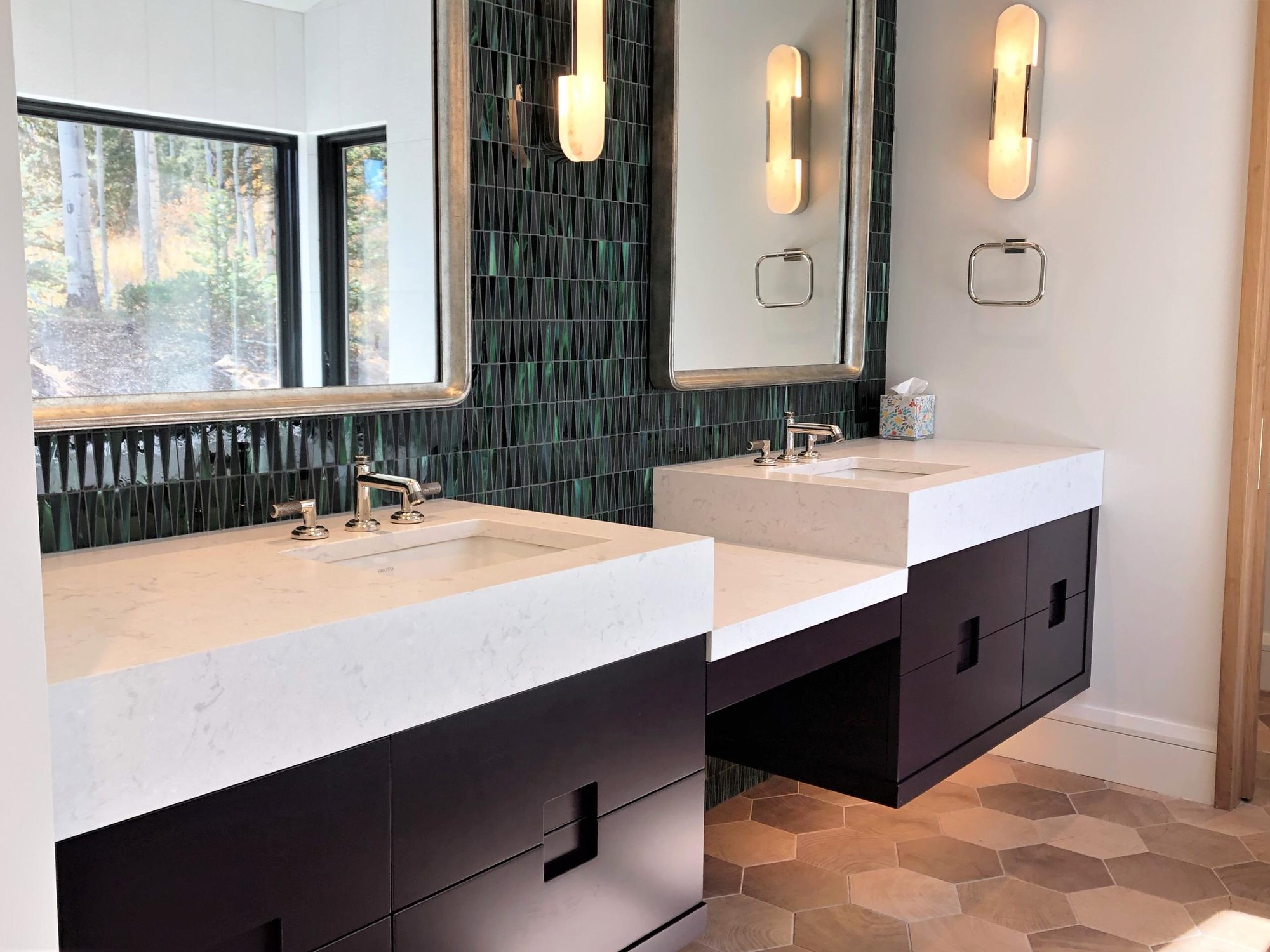 Mid-sized contemporary master green tile and glass tile wood-look tile floor, brown floor, double-sink and vaulted ceiling bathroom with flat-panel cabinets, black cabinets, white walls, an undermount sink, a hinged shower door, white countertops and a floating vanity, by Jensen Design in Telluride,