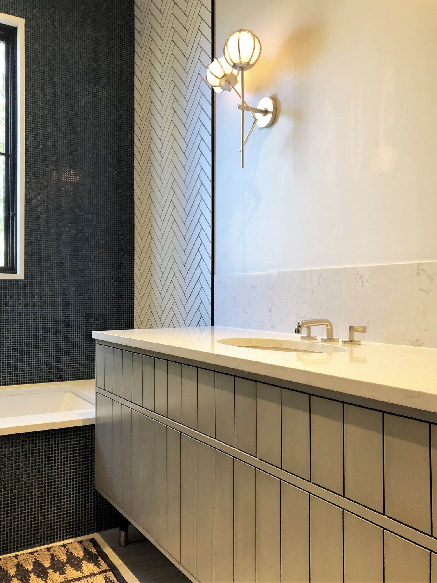 Mid-sized trendy kids' white tile single-sink drop-in bathtub with flat-panel cabinets, gray cabinets, white walls, an undermount sink, beige countertops and a freestanding vanity, by Jensen Design in Telluride, CO
