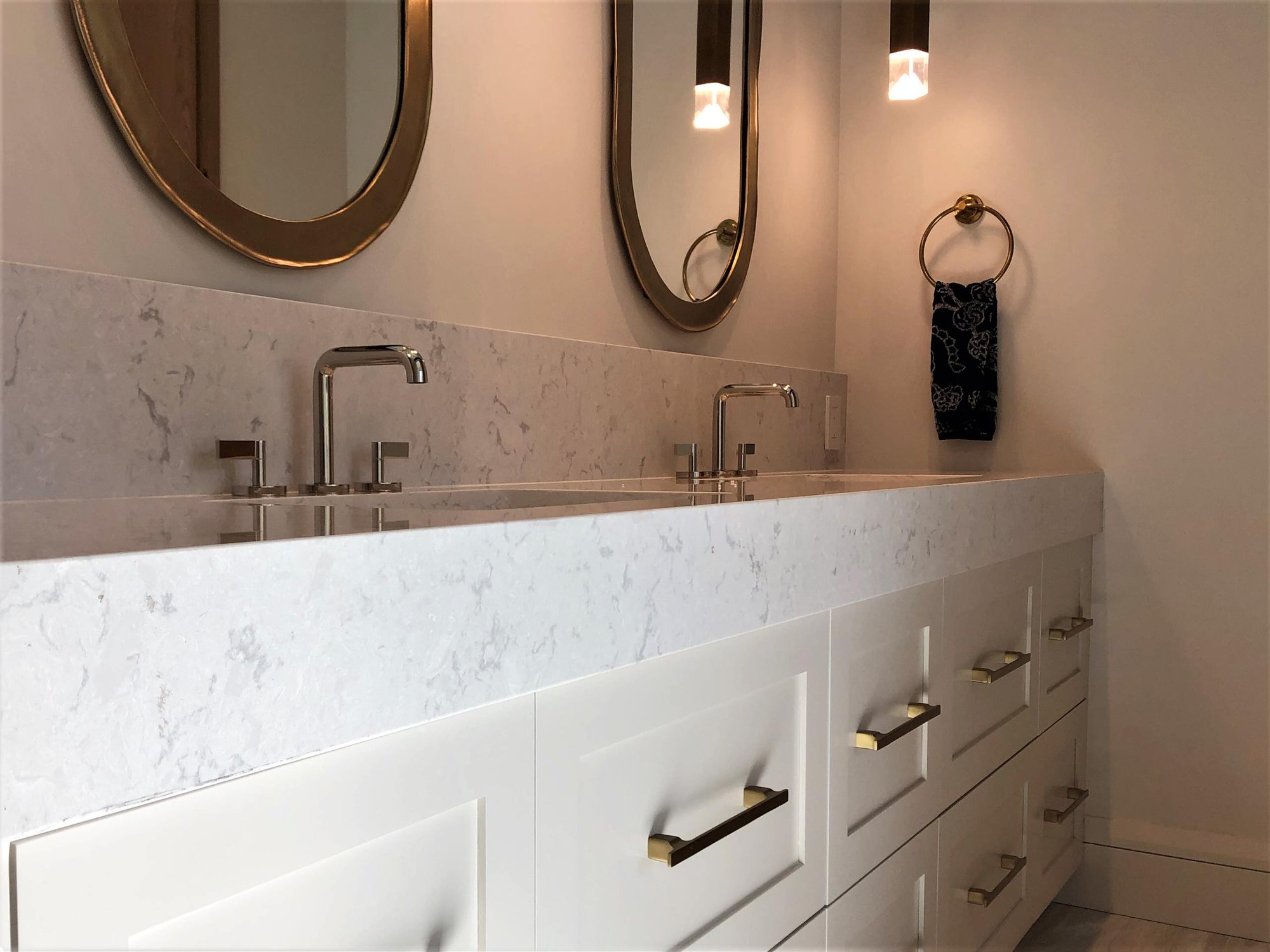 Mid-sized trendy master gray floor and double-sink toilet room with shaker cabinets, white cabinets, white walls, an undermount sink, white countertops and a built-in vanity, by Jensen Design in Telluride, CO
