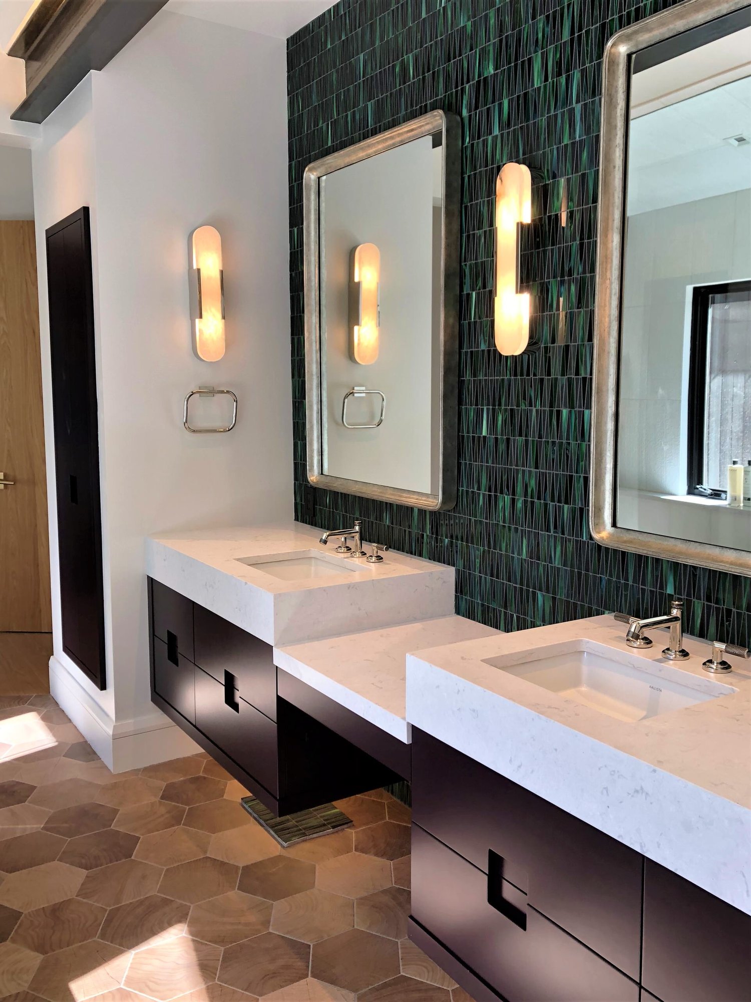 Mid-sized trendy master green tile and glass tile wood-look tile floor, brown floor, double-sink and vaulted ceiling bathroom with flat-panel cabinets, black cabinets, white walls, an undermount sink, a hinged shower door, white countertops and a floating vanity, by Jensen Design in Telluride, CO