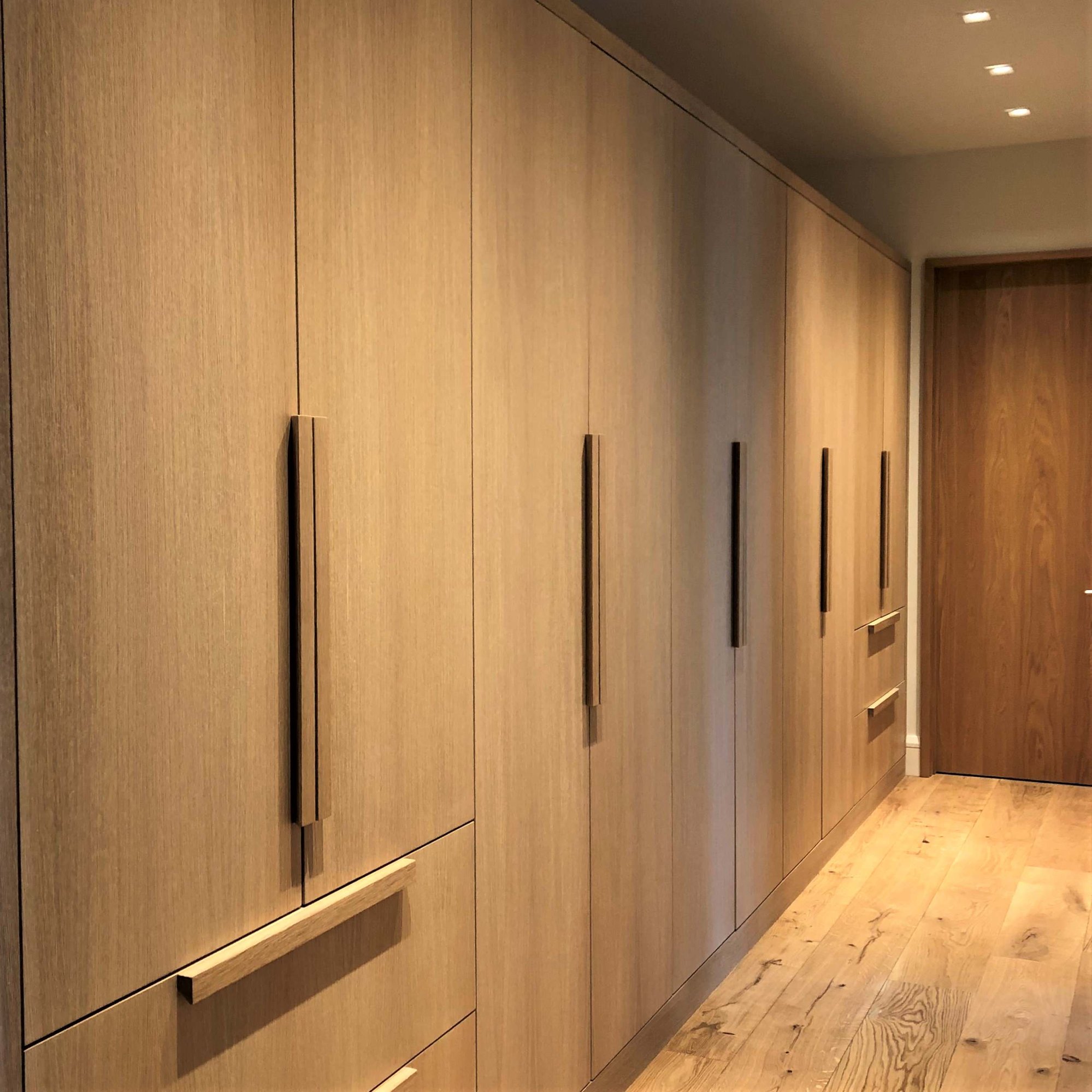 Large trendy light wood floor and brown floor hallway with brown walls, by Jensen Design in Telluride, CO