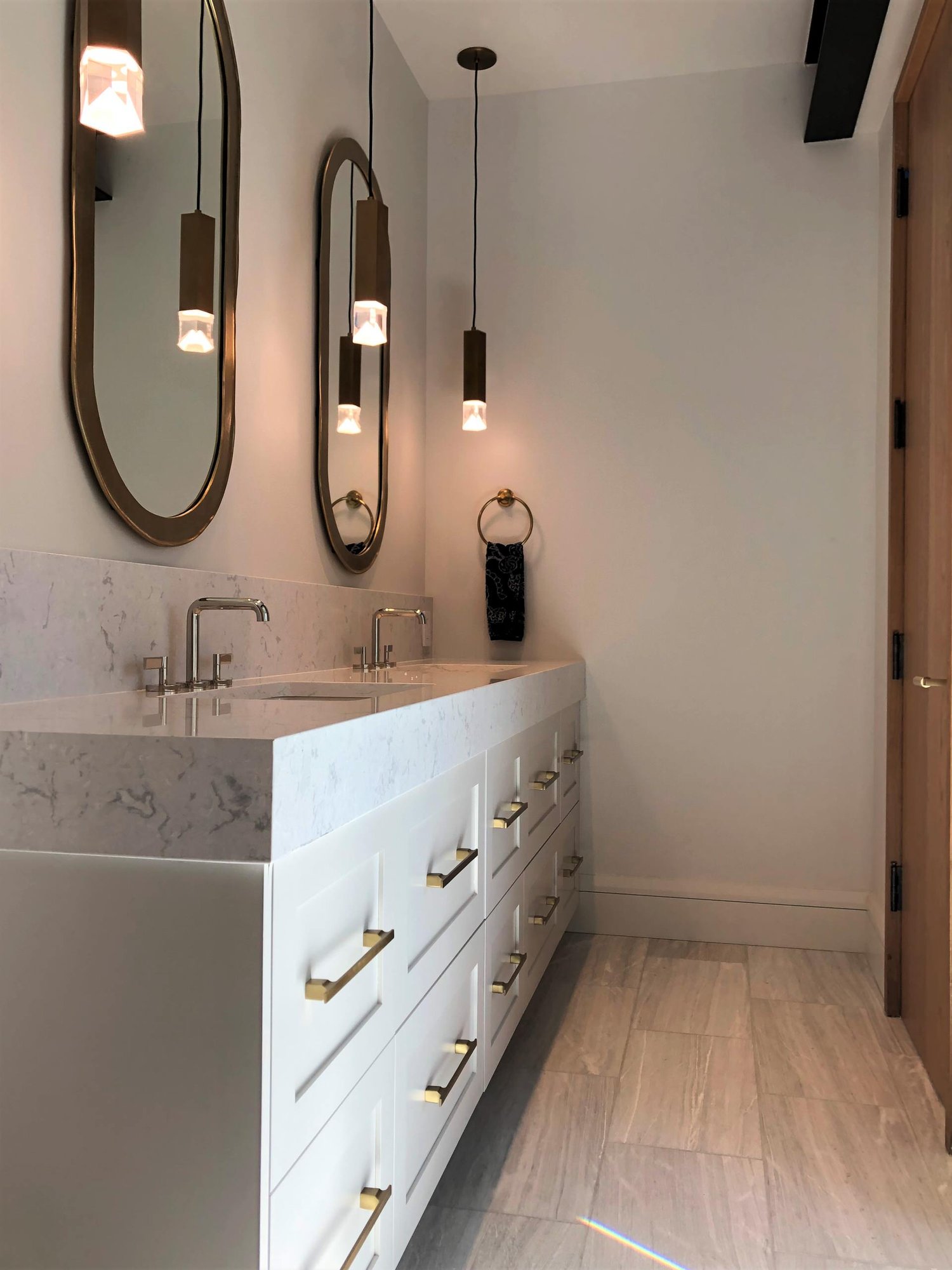 Mid-sized contemporary master gray floor and double-sink toilet room with shaker cabinets, white cabinets, white walls, an undermount sink, white countertops and a built-in vanity, by Jensen Design in Telluride, CO