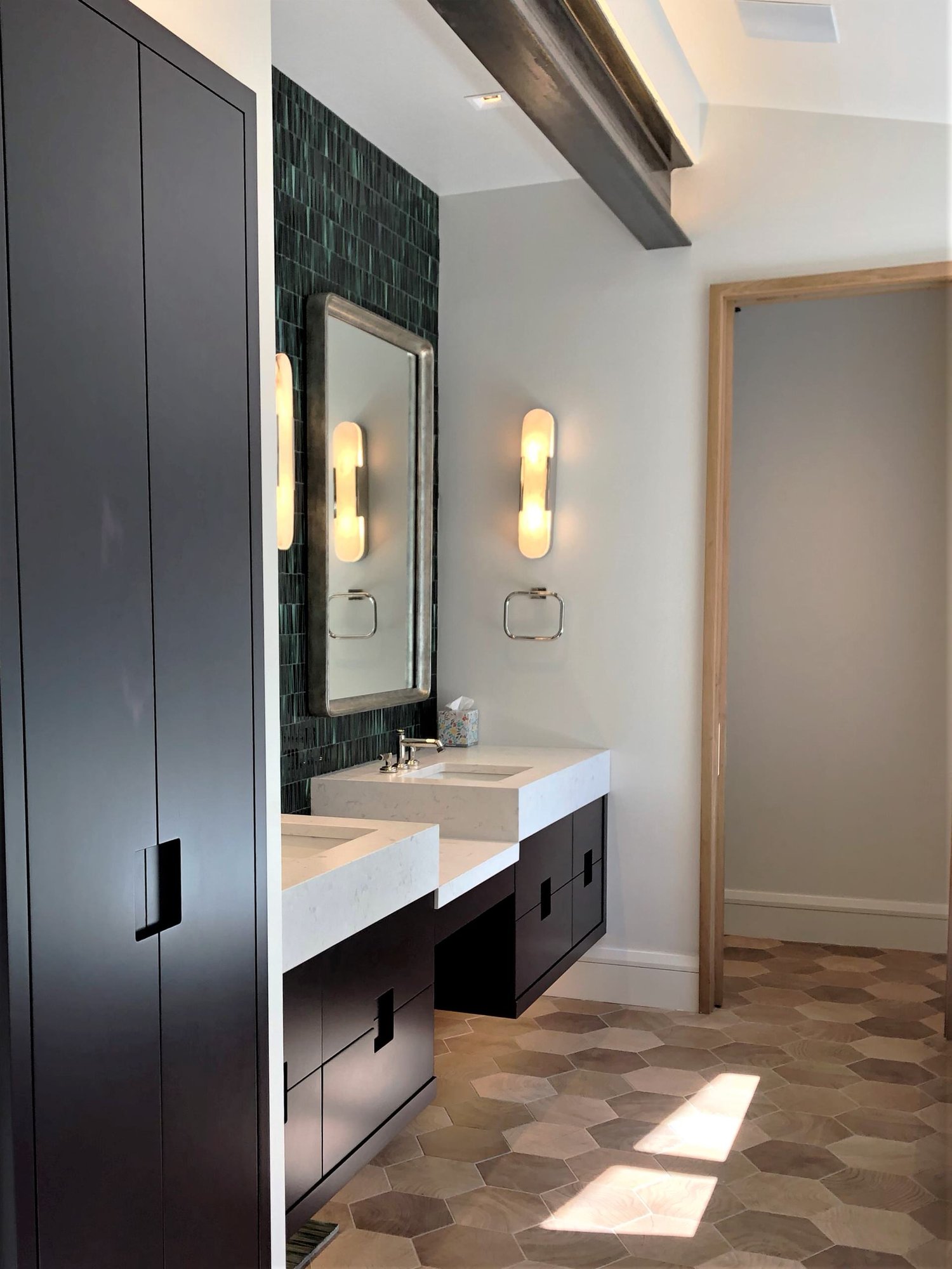 Mid-sized contemporary master green tile and glass tile wood-look tile floor, brown floor, double-sink and vaulted ceiling bathroom with flat-panel cabinets, black cabinets, white walls, an undermount sink, a hinged shower door, white countertops and a floating vanity, by Jensen Design in Telluride,
