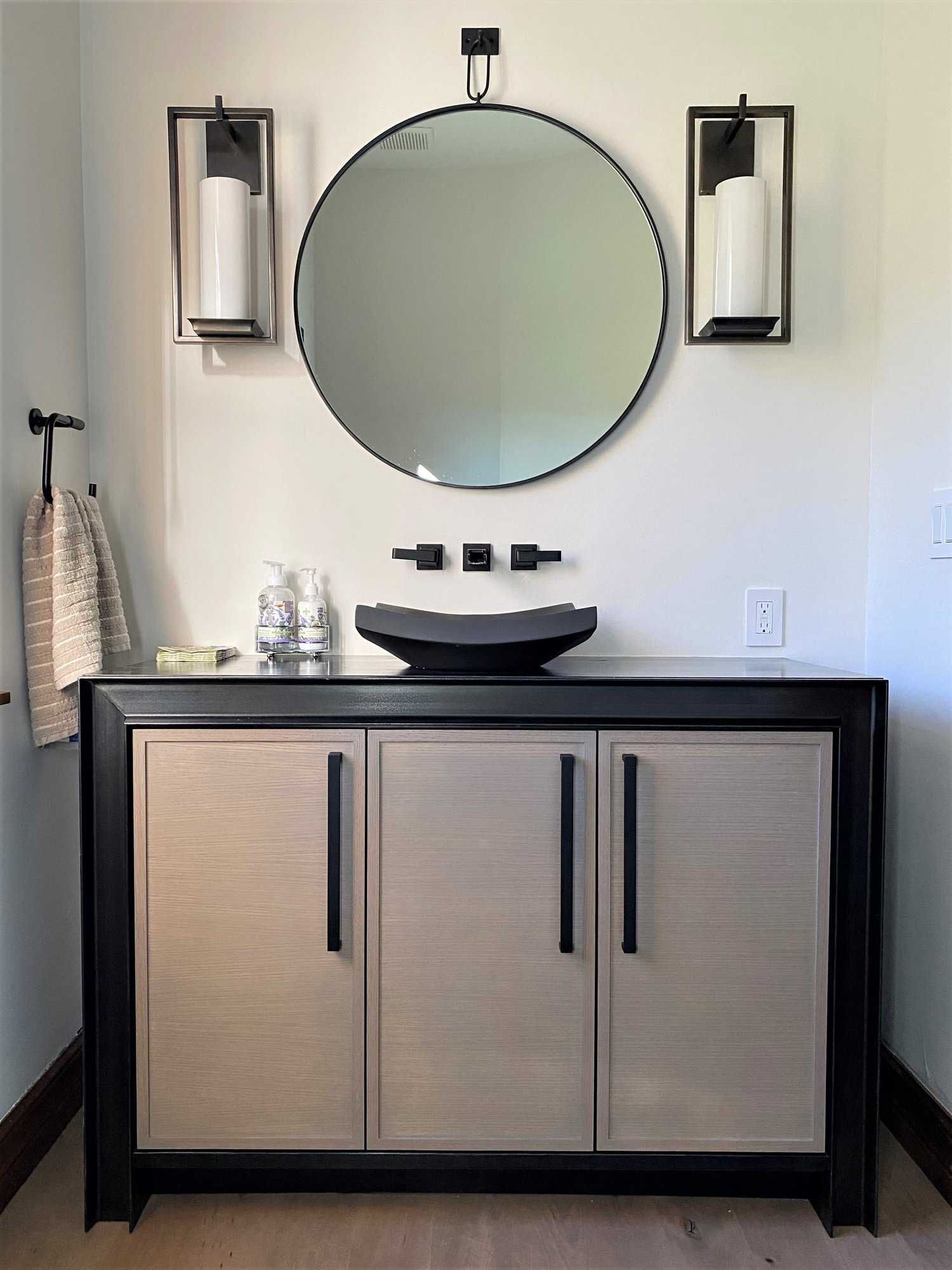 Small transitional 3/4 single-sink bathroom with recessed-panel cabinets, medium tone wood cabinets, black countertops and a freestanding vanity, by Jensen Design in Telluride, CO