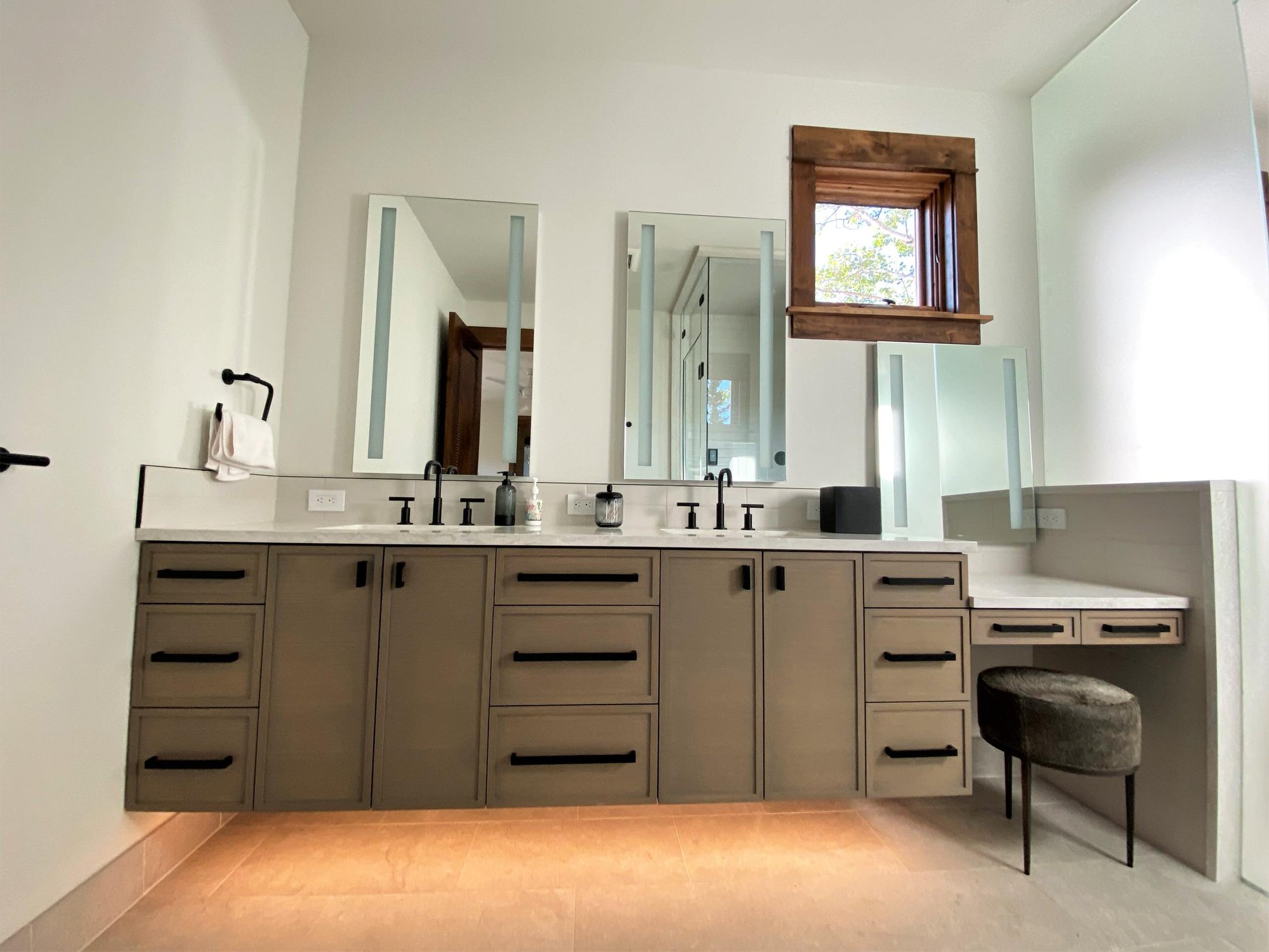 Mid-sized transitional master white tile double-sink bathroom with recessed-panel cabinets, medium tone wood cabinets, white walls, an undermount sink, white countertops and a floating vanity, by Jensen Design in Telluride, CO