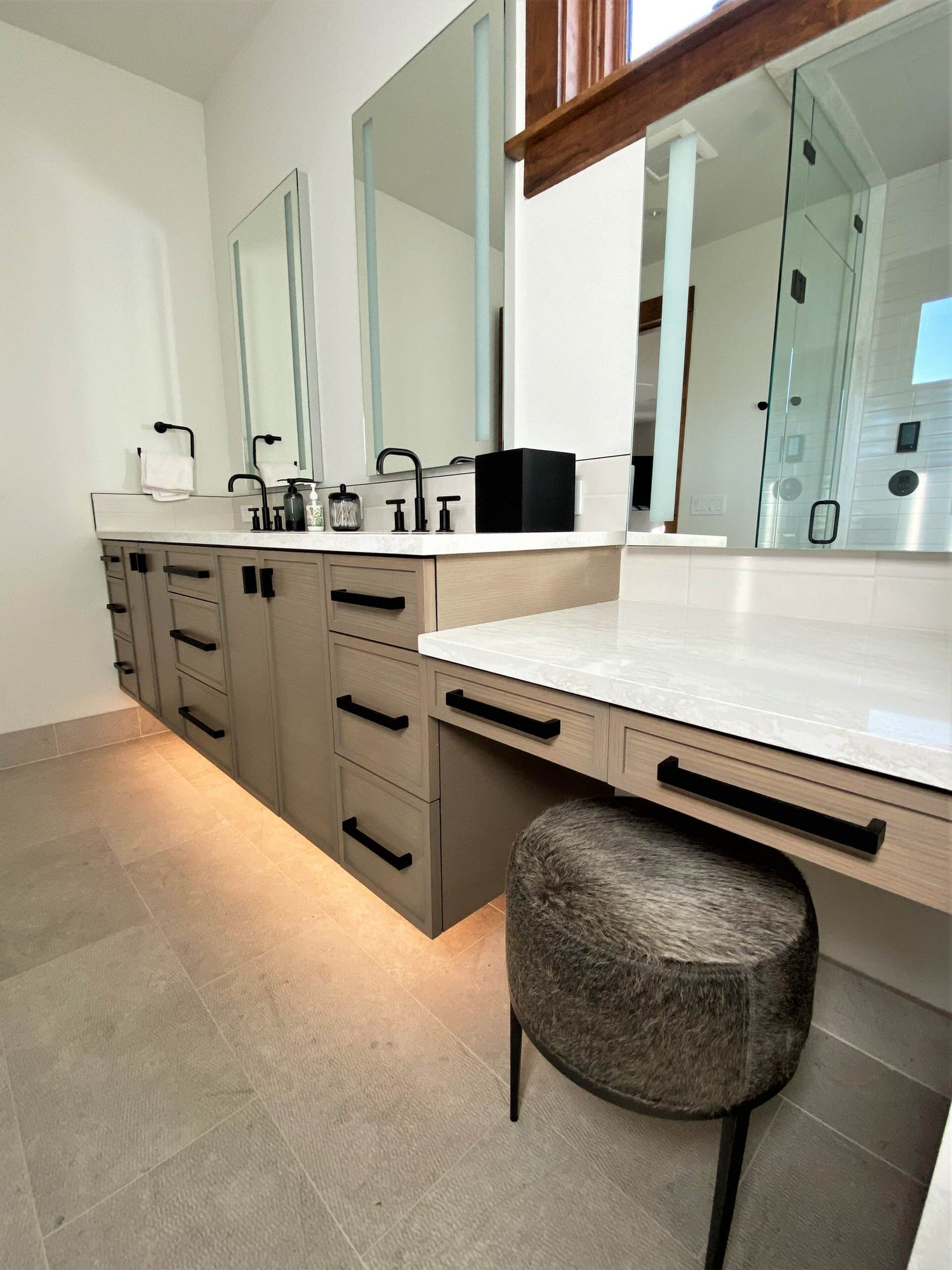 Mid-sized transitional master white tile double-sink bathroom with recessed-panel cabinets, medium tone wood cabinets, white walls, an undermount sink, white countertops and a floating vanity, by Jensen Design in Telluride, CO