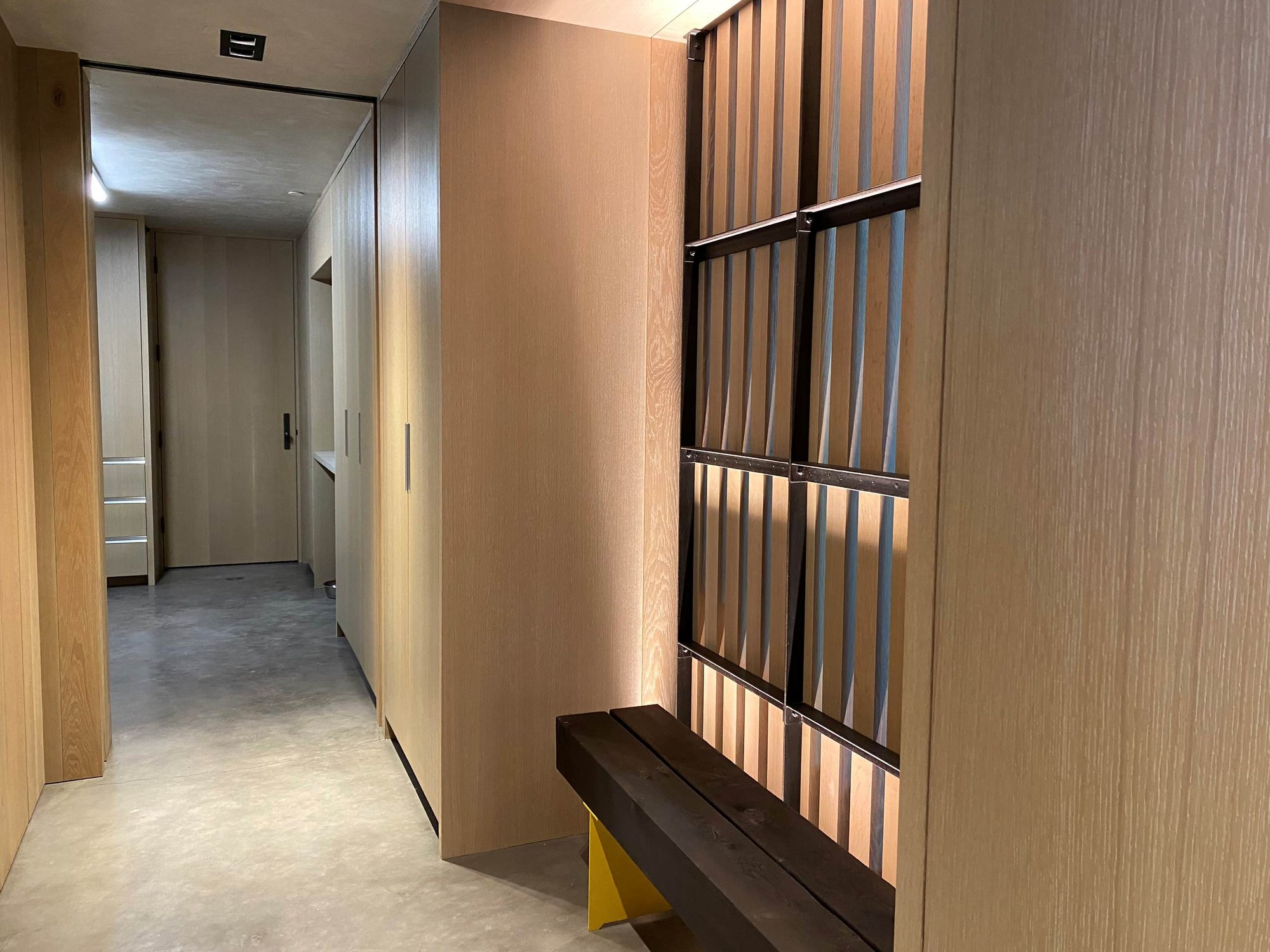 Mid-sized contemporary concrete floor, gray floor and wood wall hallway, by Jensen Design in Telluride, CO