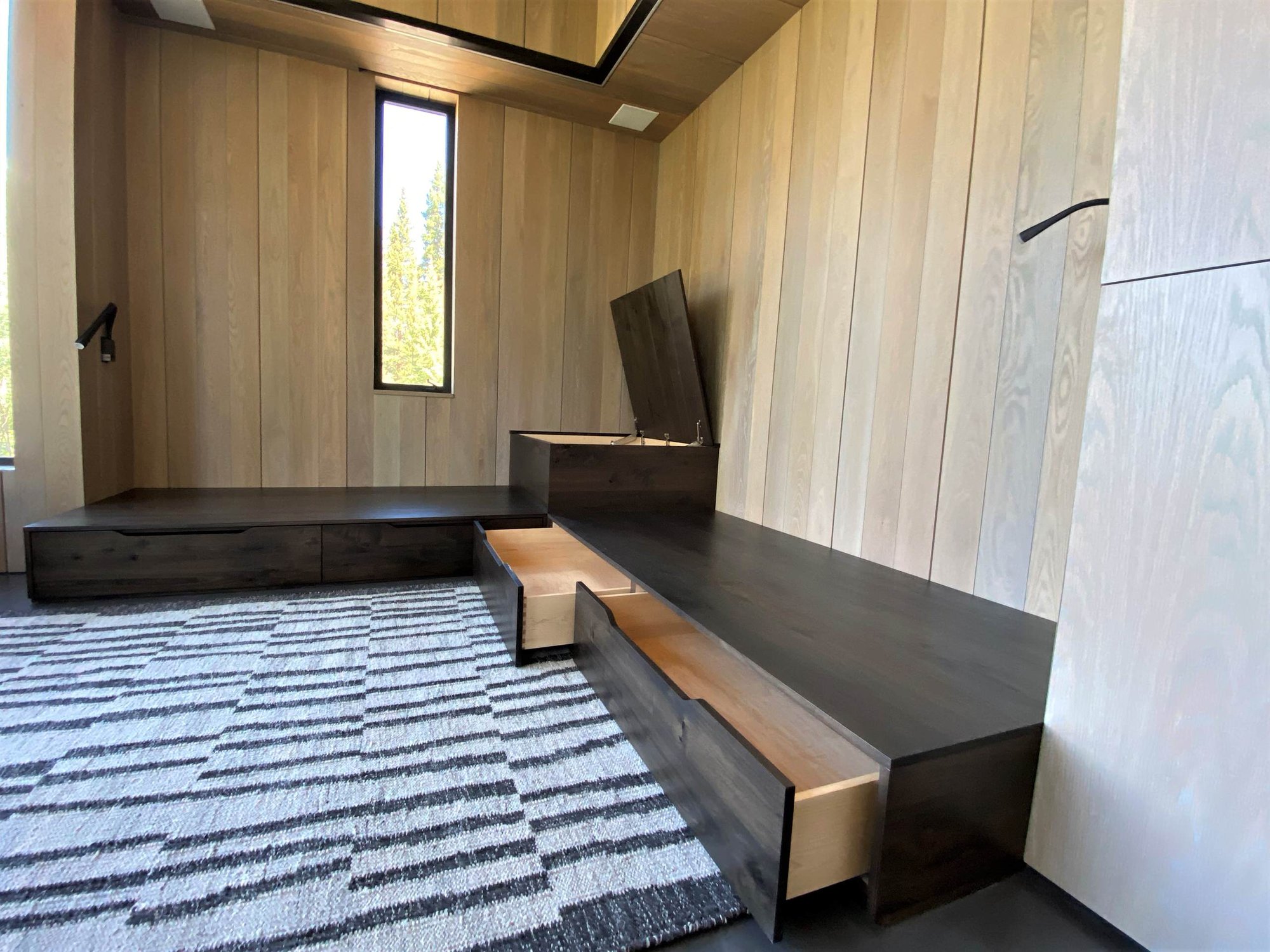 Mid-sized trendy enclosed concrete floor, gray floor, wood ceiling and wood wall family room, by Jensen Design in Telluride, CO