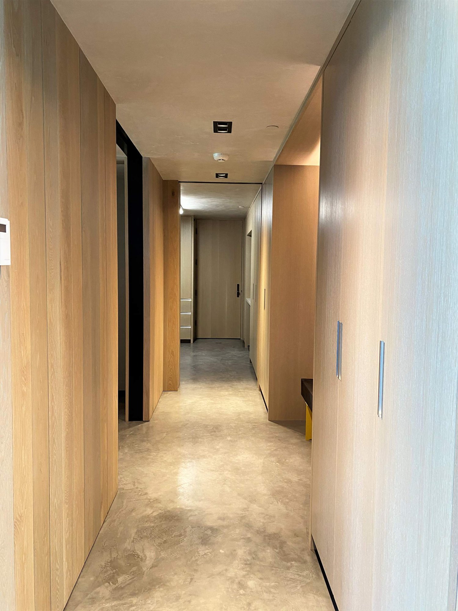 Mid-sized contemporary concrete floor, gray floor and wood wall hallway, by Jensen Design in Telluride, CO